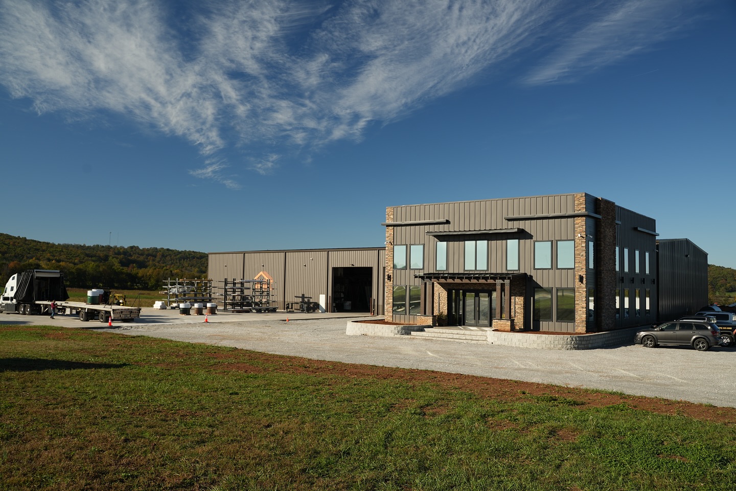 black standing seam metal roof in fayetteville arkansas with a rock chimney