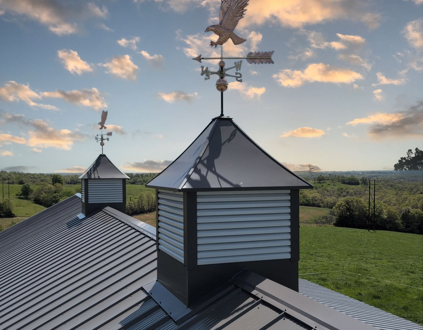 black standing seam metal roof in fayetteville arkansas with a rock chimney