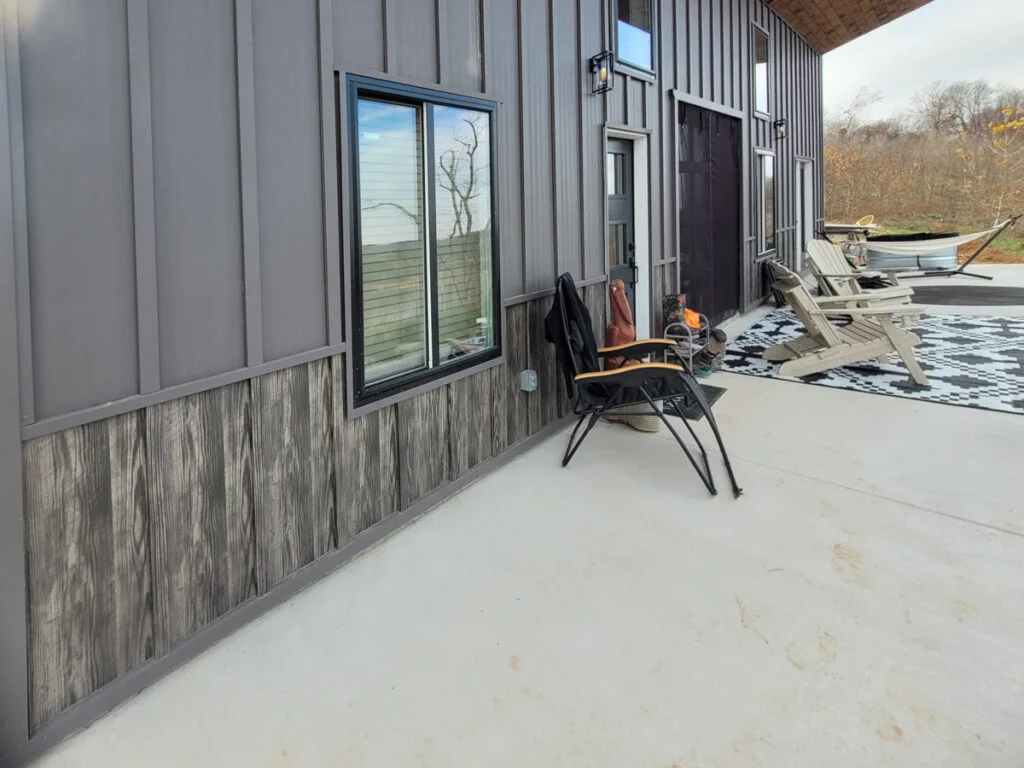 Board and Batten metal siding on a barndominium from Signature Steel with a wood-grain designer metal used for accent.