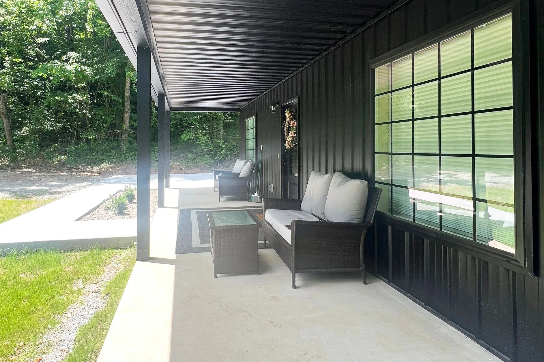 angled view of the porch on a Barndominium project built by Yutzy Construction in Elkins, AR with Black Ag Panel Metal Siding