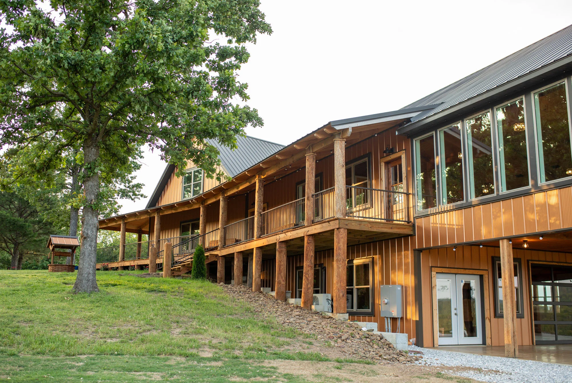 large wedding venue with dark metal roofing and copper colored metal siding