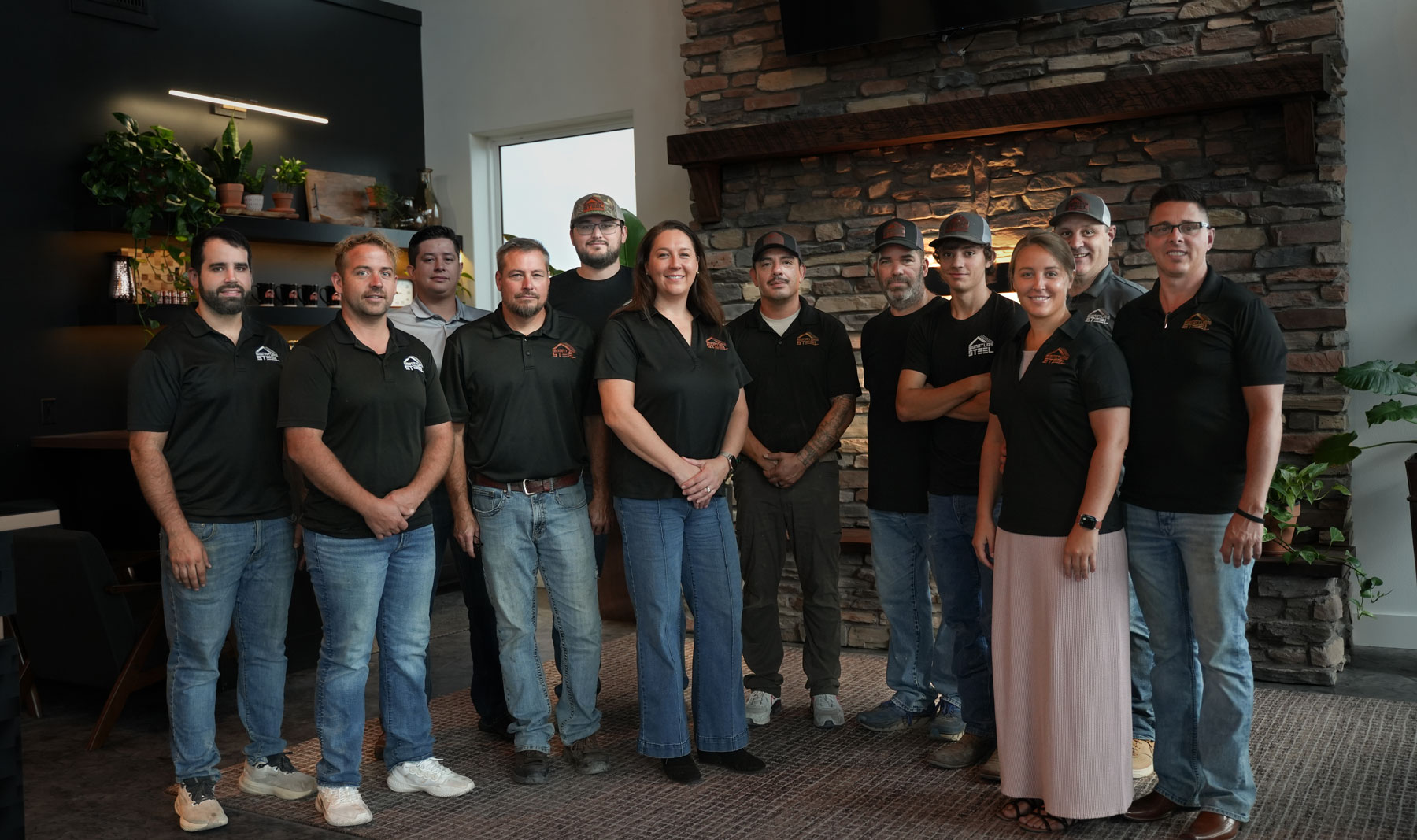 black standing seam metal roof in fayetteville arkansas with a rock chimney